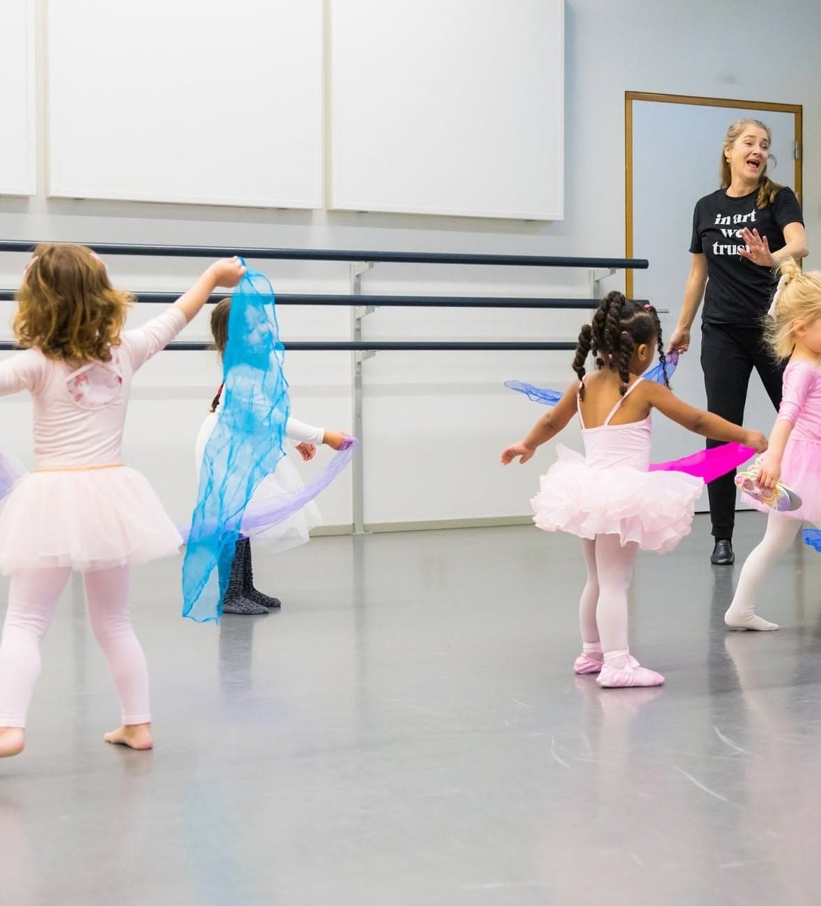 Helga geeft peuterles: kinderen in tutu dansen met blauwe en roze sjaals